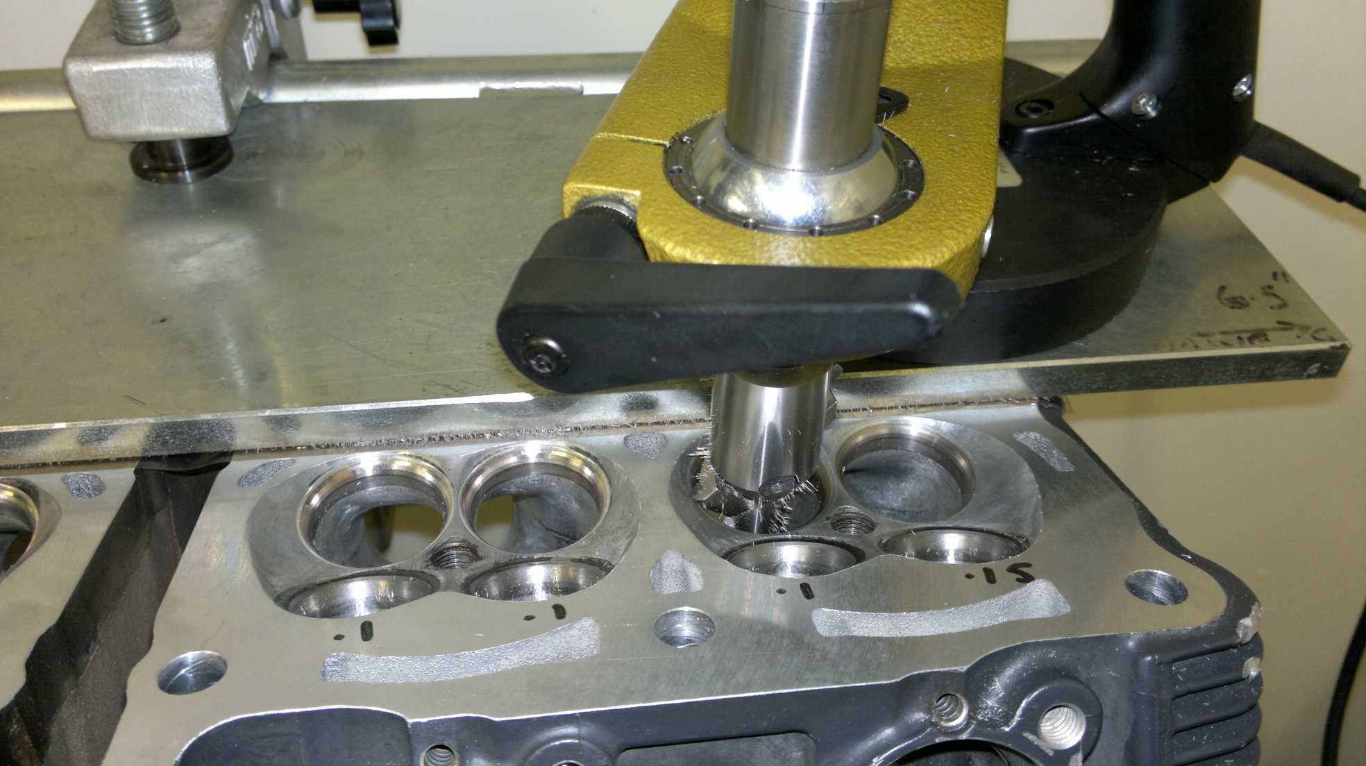 Precision valve seat machining of ported motorcycle cylinder head.